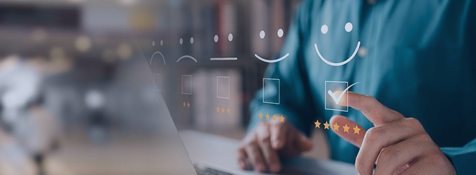 Retail analyst using customer feedback dashboard with rating icons on a laptop screen