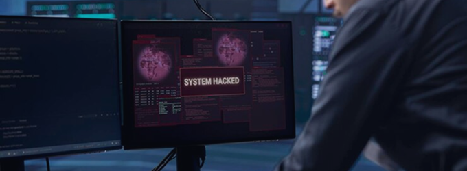 Security analyst responds to a live system breach notification on a monitoring dashboard in a SOC environment
