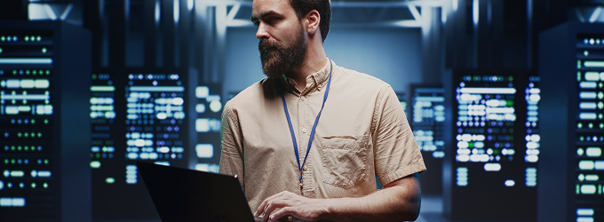 IT specialist configuring network settings on a laptop during server maintenance