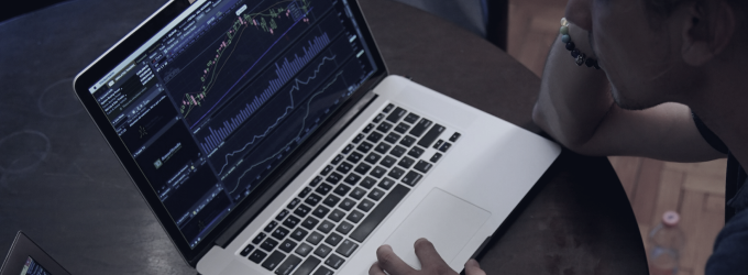 Trader analyzes live stock charts and technical indicators to inform investment decisions on laptop.
