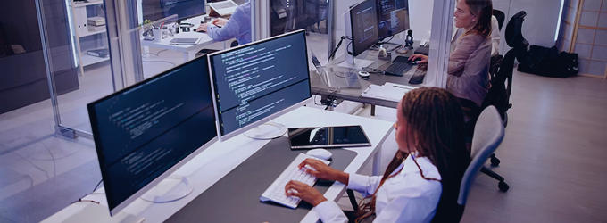 Security analysts performing penetration testing and code analysis in a modern office
