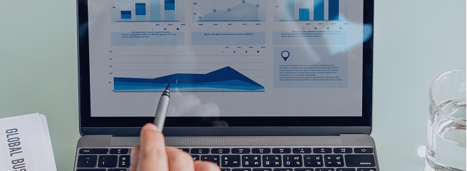 Detailed examination of key metrics on a laptop to inform operational adjustments
