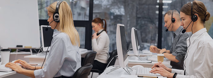IT support specialists handling client inquiries at a busy technical service center.