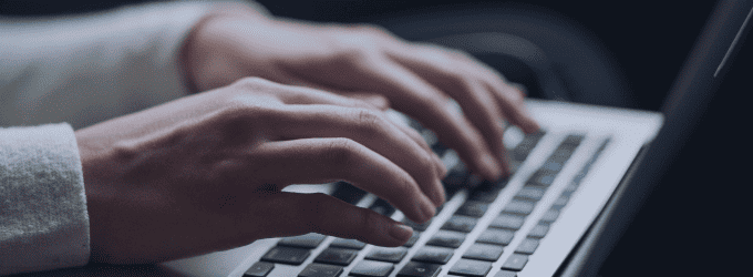 Developer working on code and system updates with a laptop against a high-tech digital background