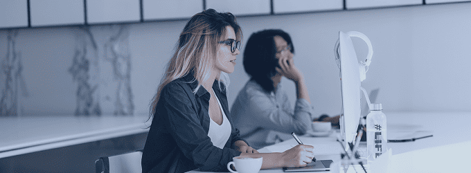 IT team collaborating on projects, with a developer focused on code and a teammate discussing tasks by phone