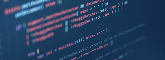 Programmer inspecting complex functions displayed on a screen in a digital development environment