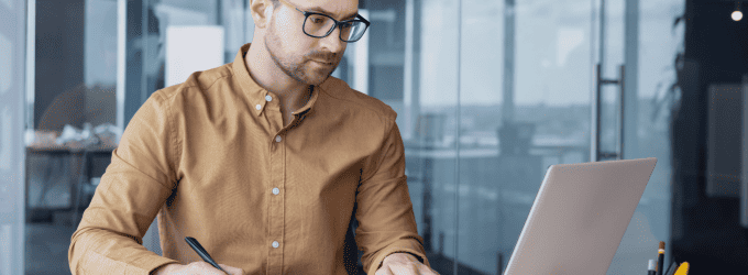 Software engineer managing tasks on a laptop, focused on a project in a technology-driven environment