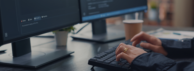 Developer writing and testing code on dual monitors during a software development session