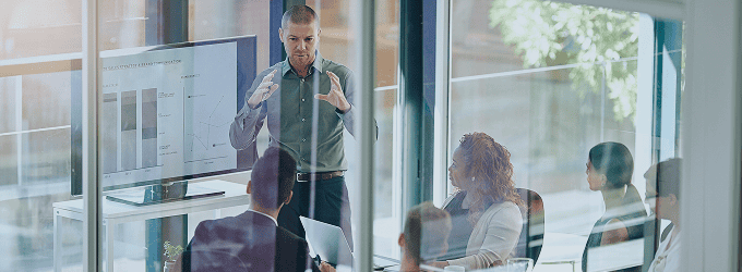 Business meeting focused on digital transformation and workflow automation in a modern glass office