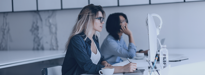 IT team collaborating on projects, with a developer focused on code and a teammate discussing tasks by phone.