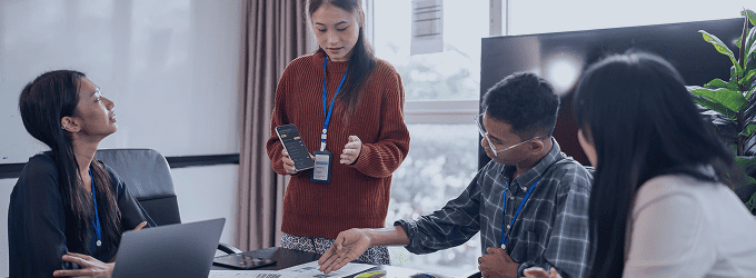 Tech team reviewing UX concepts and mobile solutions at a product design session
