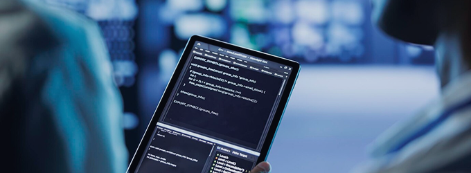 Developer presenting code on a tablet in a teamwork-focused development environment