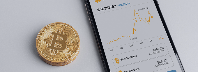 Investor reviews market data, using a mobile wallet app to analyze Bitcoin’s value fluctuations