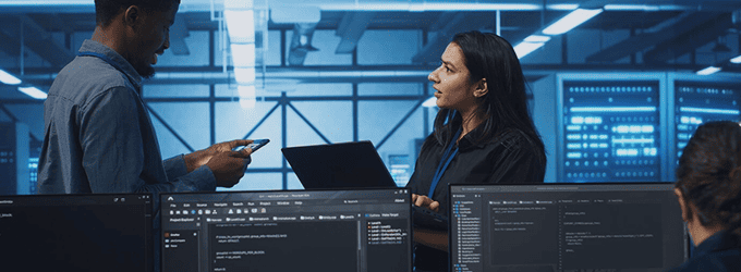 Software consultants coordinating on technical tasks for agile development and IT security management