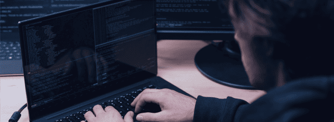 IT specialist focused on software engineering and debugging at a dual-screen setup