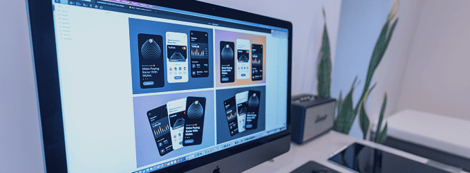 Design process for app prototypes shown on a large computer monitor, highlighting visual layout options