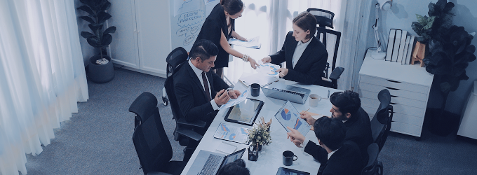 IT project team collaborating on digital transformation strategy in a boardroom meeting